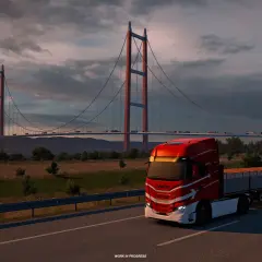 Czerwona ciężarówka na moście, zachód słońca. Idealna grafika do sprawdzenia wymagań Euro Truck Simulator 2.