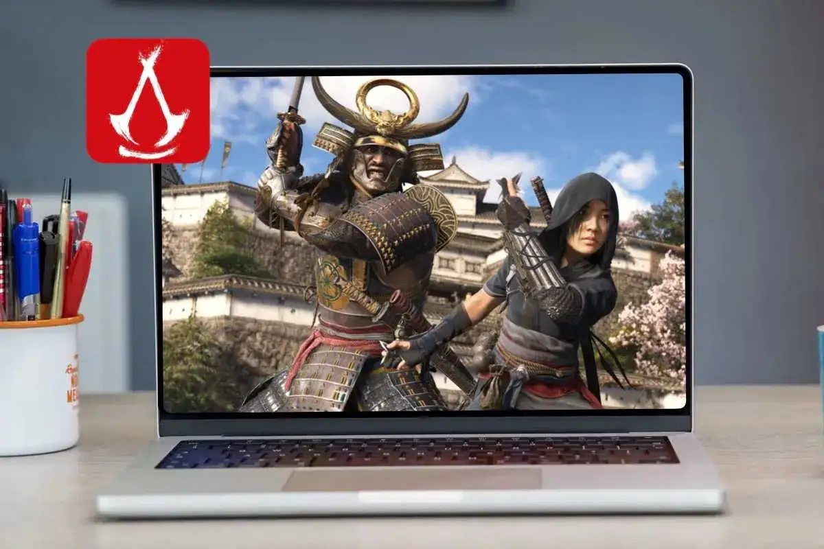 Laptop z grą na mac. Widok na ekranie: wojownik w zbroi samuraja i kobieta w kapturze, gotowi do walki.