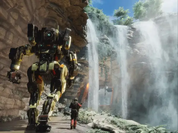 Potężny mech z gry Titanfall 3 stoi obok wodospadu, a pilot w skafandrze bojowym wpatruje się w niego.